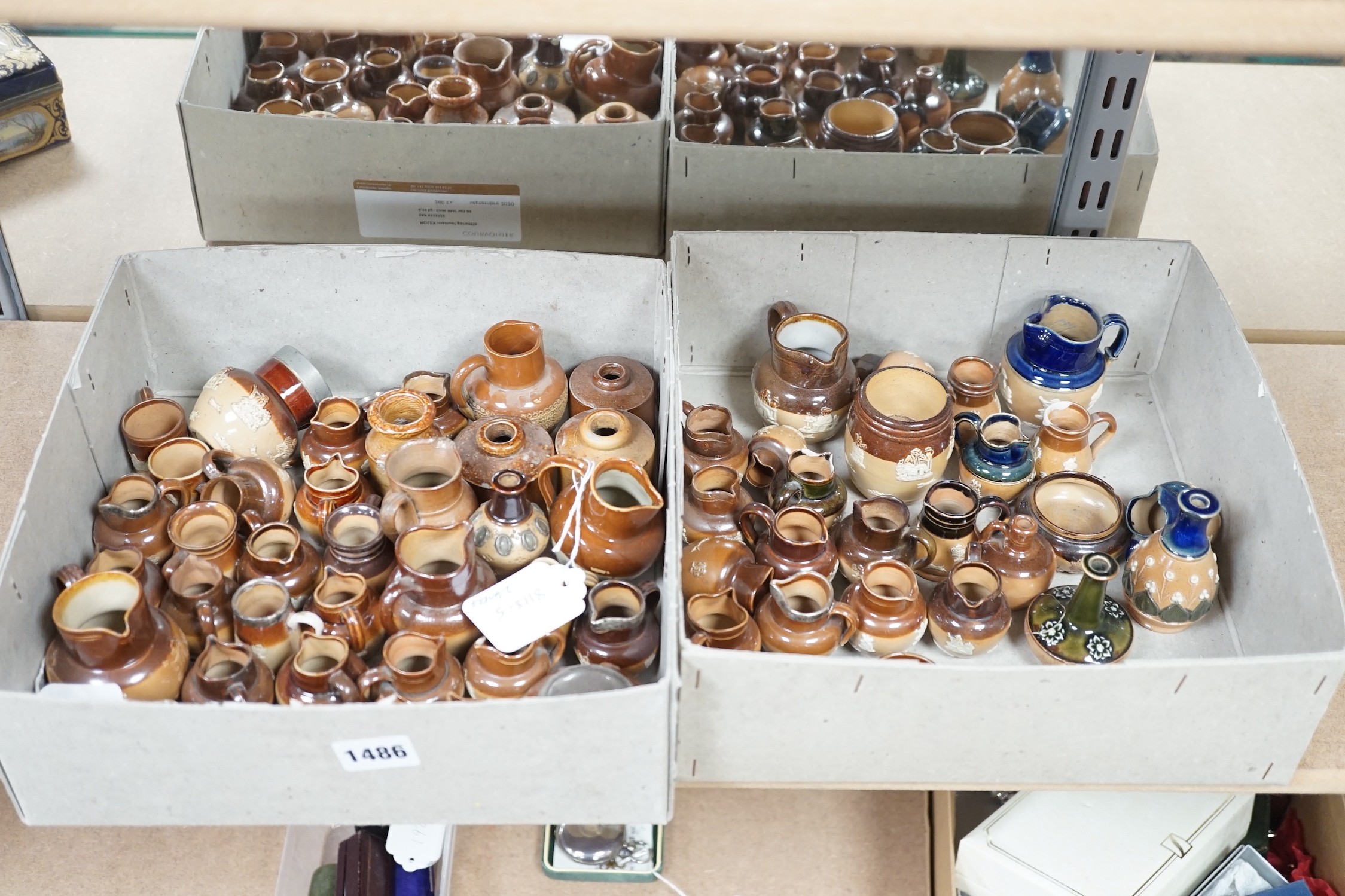 A large collection of brown stoneware miniature vessels, mostly Doulton